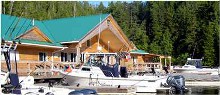 Main lodge with fishing boats at Barkley Sound Lodge