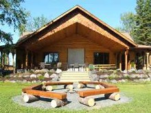 Log guest cottage with fire pit at Bakers Narrows Lodge