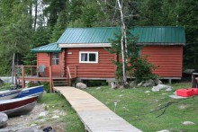 Guest cabin and boat at Pipestone Lodge