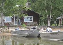Waterfront cabin with boats at Sandy Beach Lodge