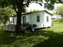 Guest cabin with deck and grill at Sunset Cove