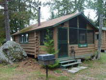Guest cabin with lake view at Timber Point Camp
