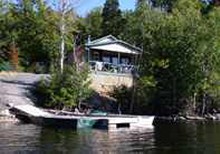 Lakefront guest cabin with boat dock at Pourvoirie Domaine Bazinet