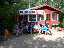 Fishermen standing by lodge sign