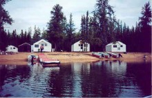 View from lake of cabins and boats at George Lake Camp Outfitting