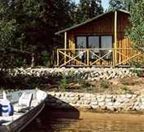 Waterfront cabin with boat at Hatchet Lake Lodge