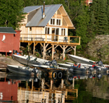 Lakefront guest cabin with boats at Oliver Lake Wilderness Lodge