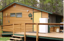 Log guest cabin with deck at Reel'em Inn Cabins